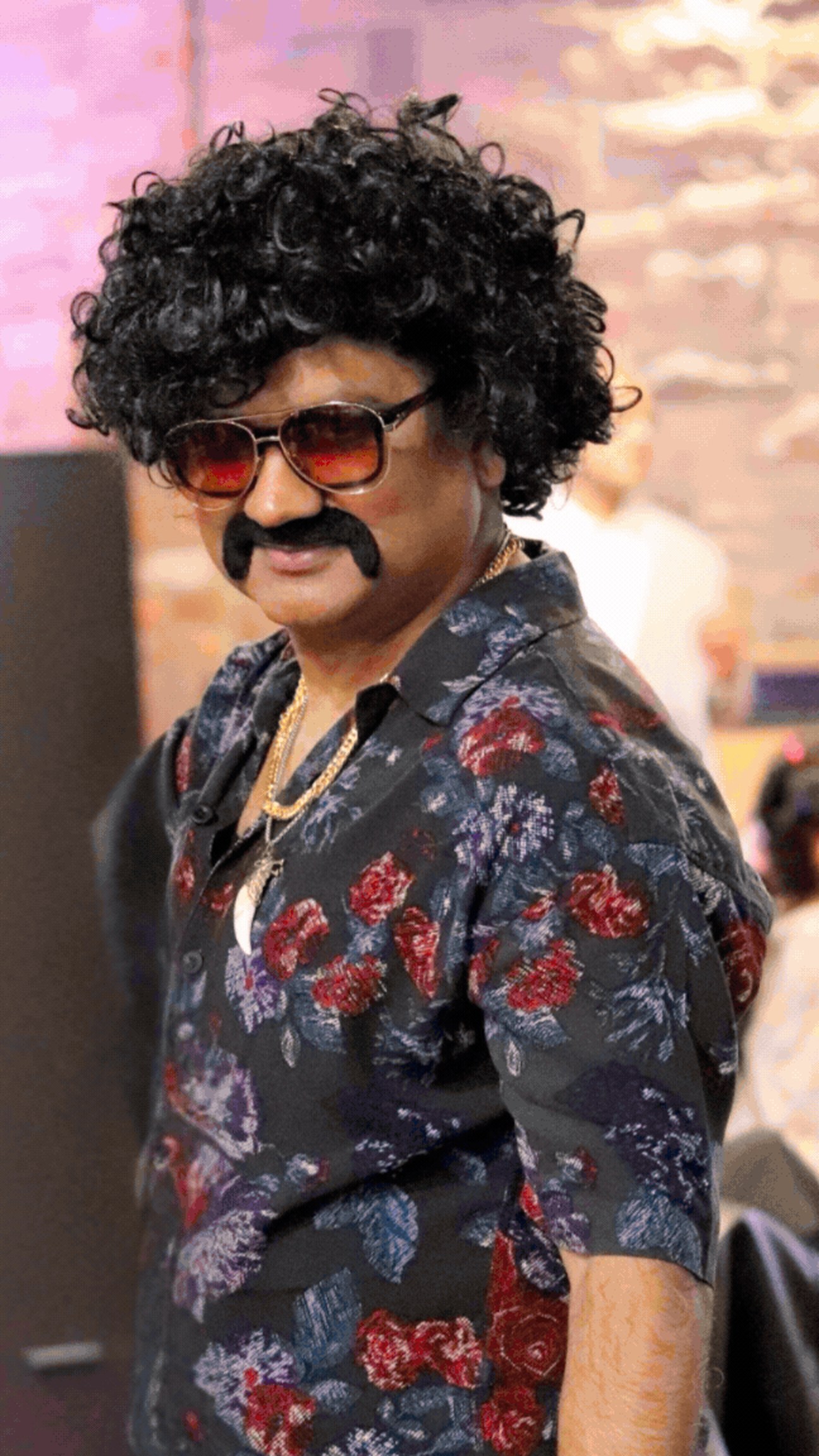 Best dressed retro winner in a floral shirt, curly afro wig, moustache and tinted aviators
