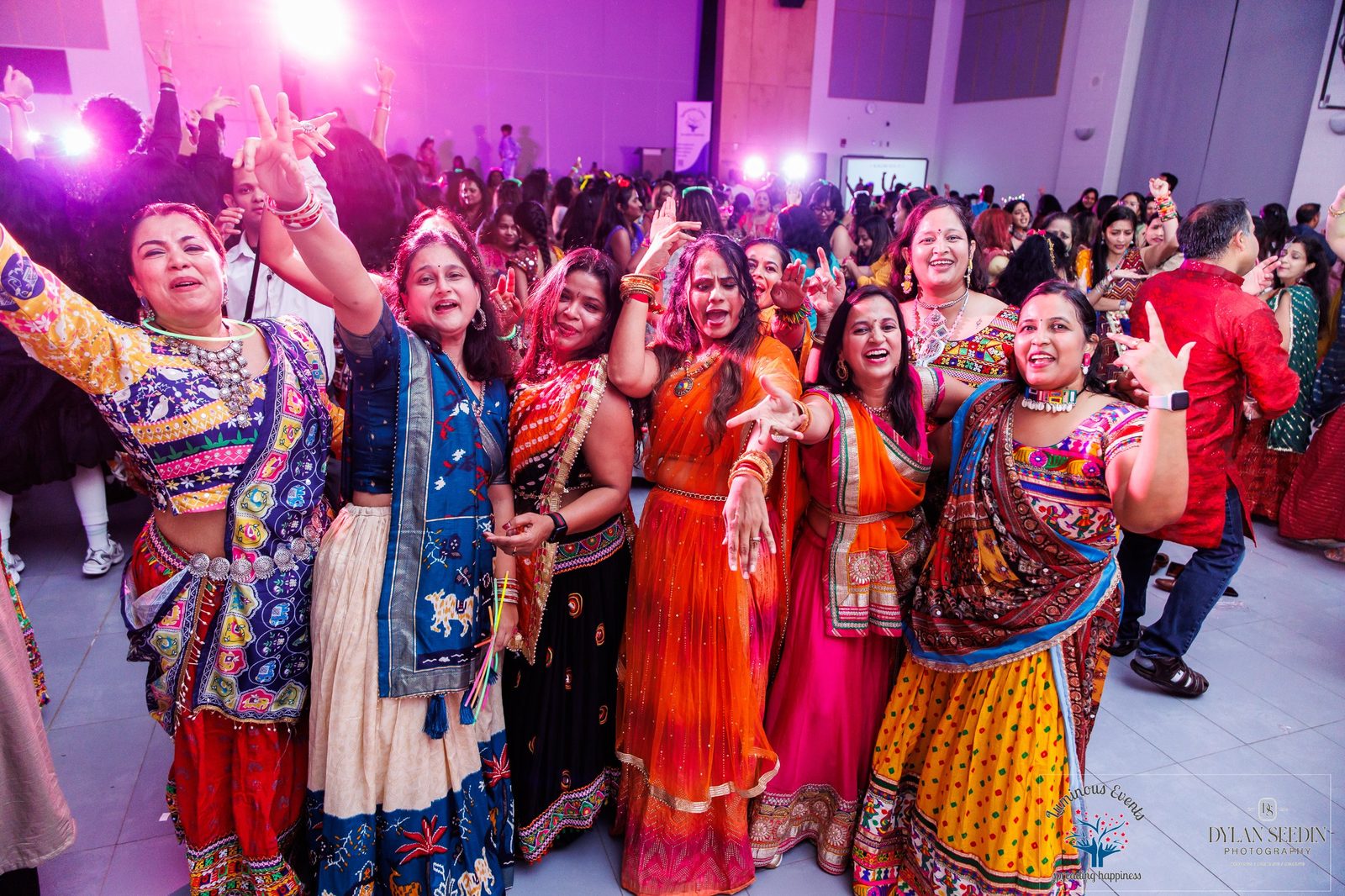 Friends cheering and dancing on the Garba dance floor