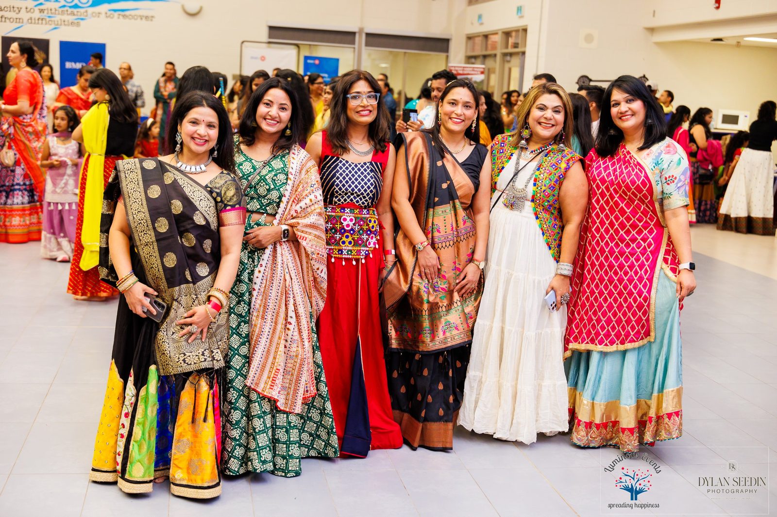 Six friends in traditional Garba outfits lined up for a group photo