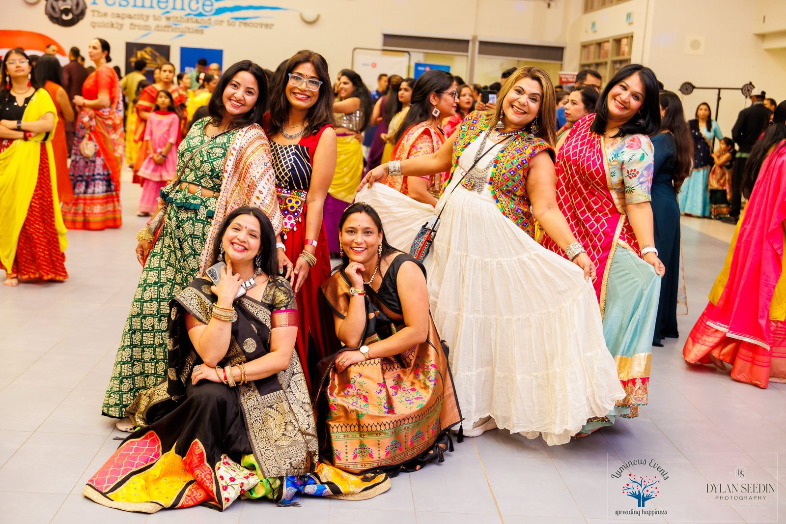 Friends in colourful outfits striking a playful pose