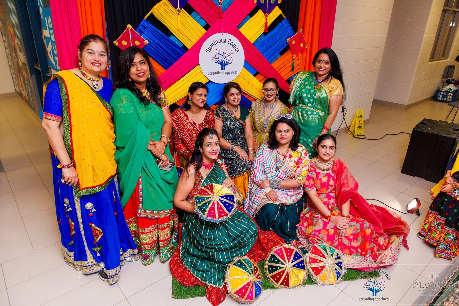 Guests posing with the Luminous Events kite photo backdrop