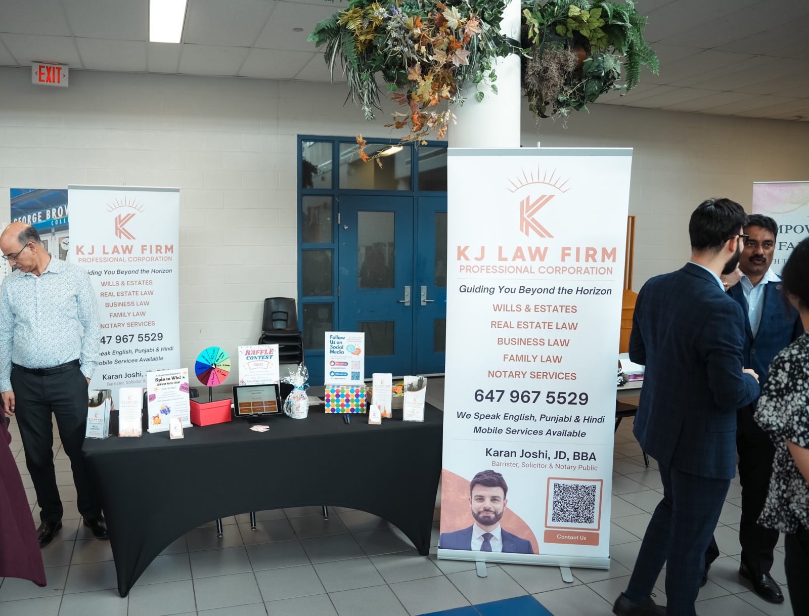 KJ Law Firm booth with a raffle contest, spin-to-win wheel and banner