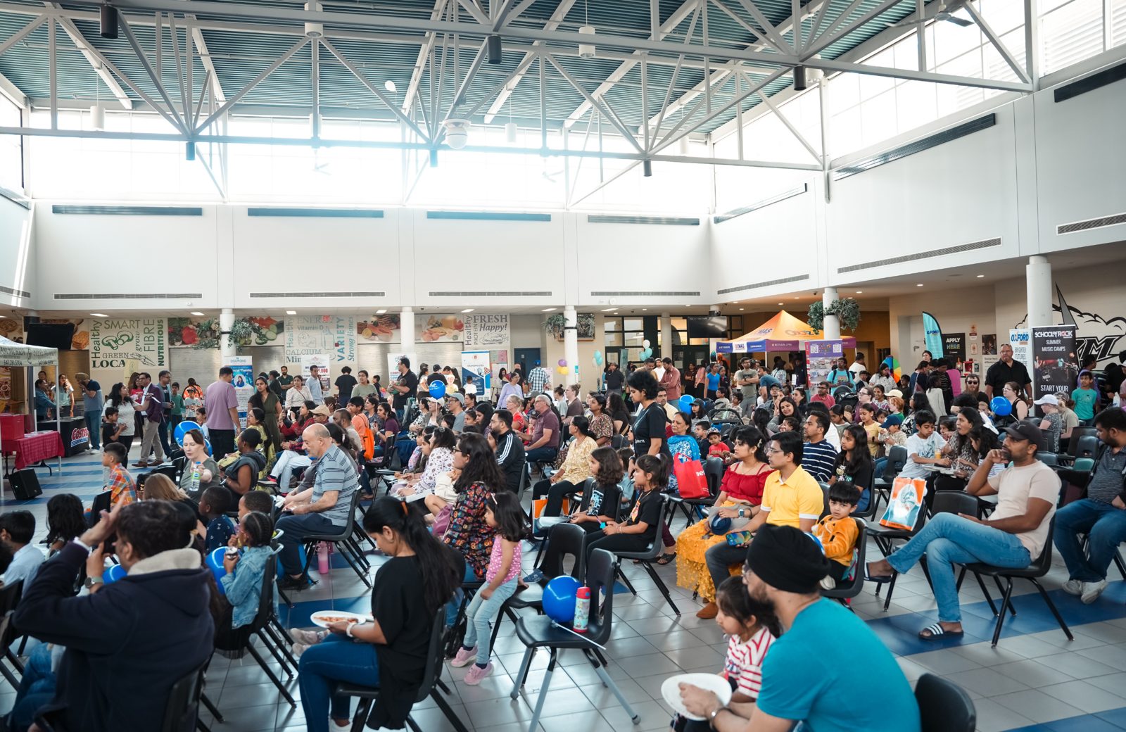 A packed hall of families and children seated to watch the magic show