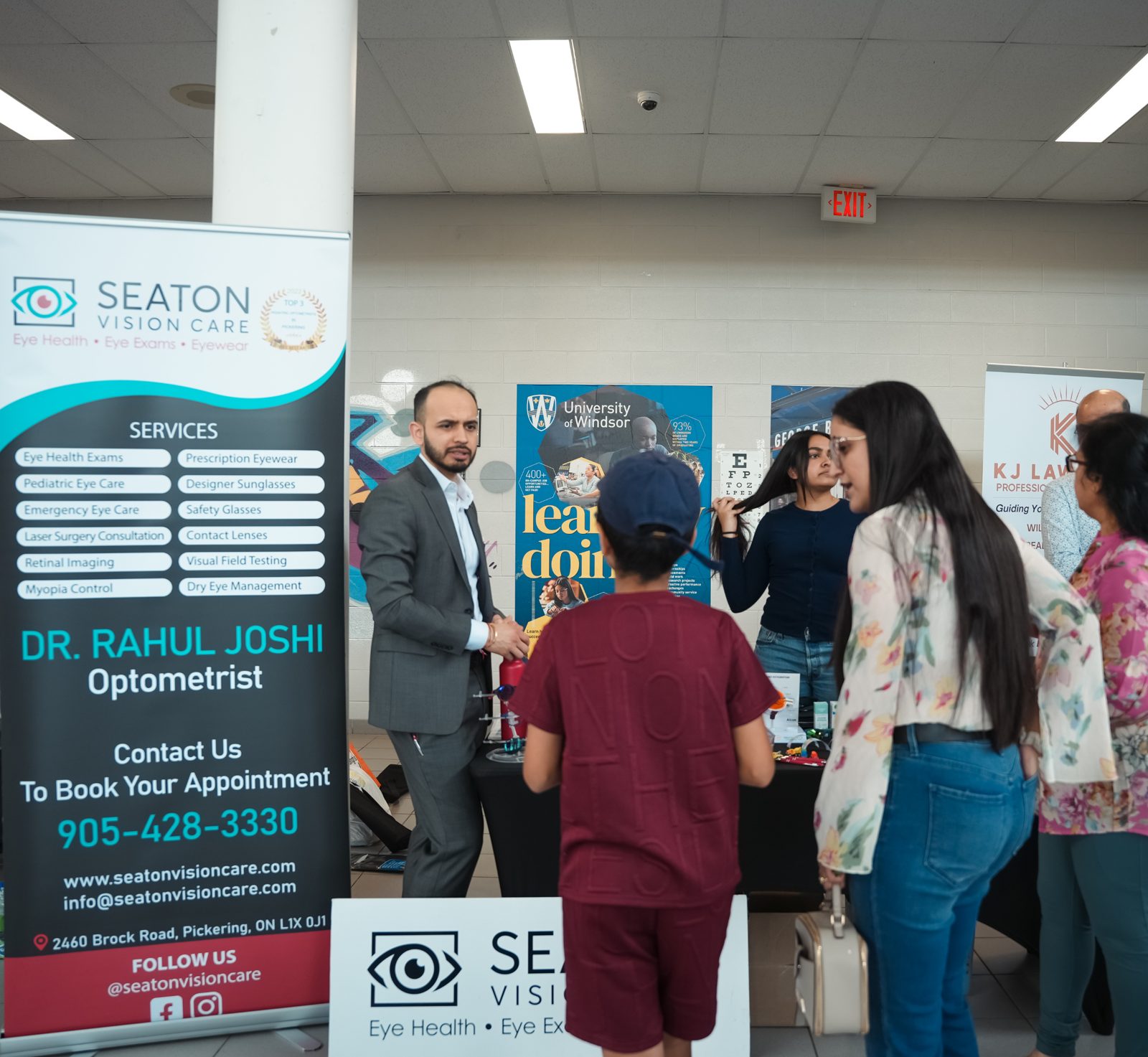 Seaton Vision Care booth where an optometrist speaks with a child and parents