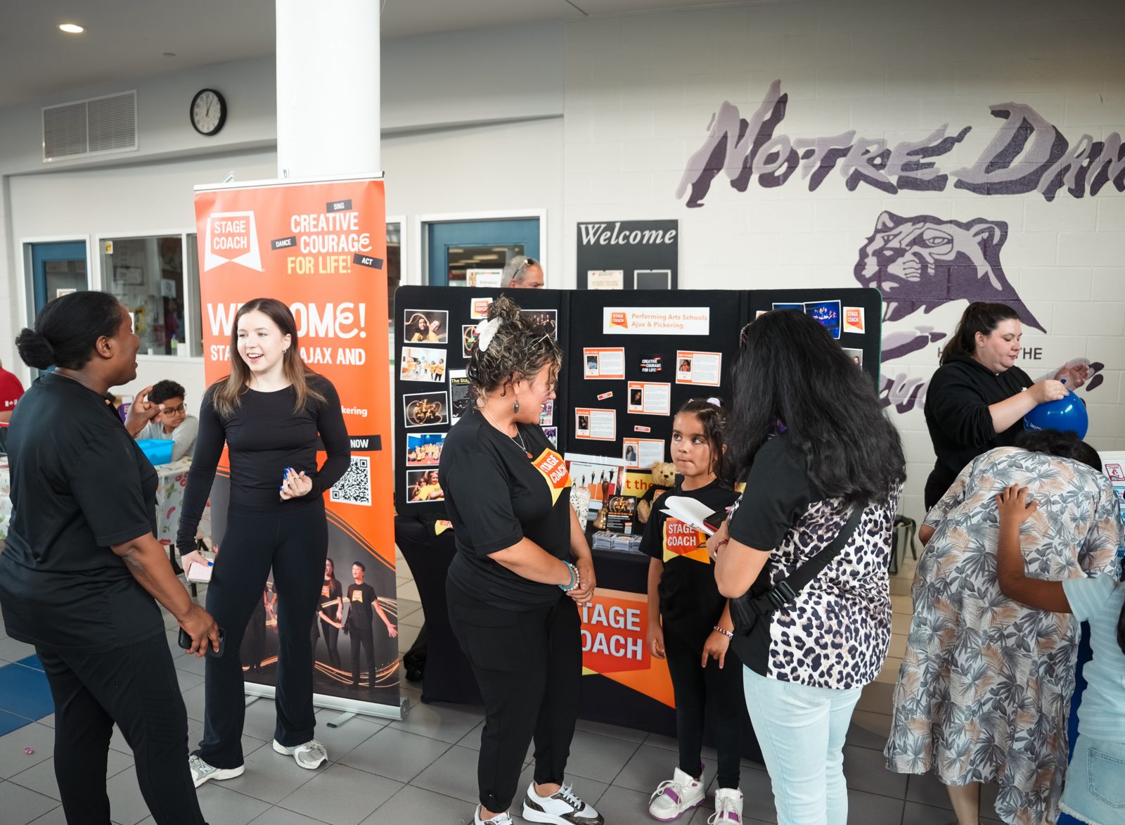 Stage Coach Performing Arts Schools booth with teachers chatting to families